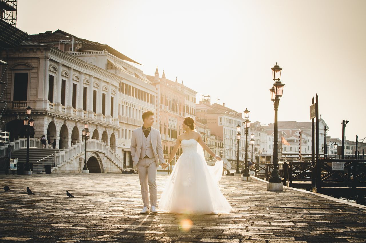 Bride and groom aboard BELLA, a 1963 mahogany boat in Venice