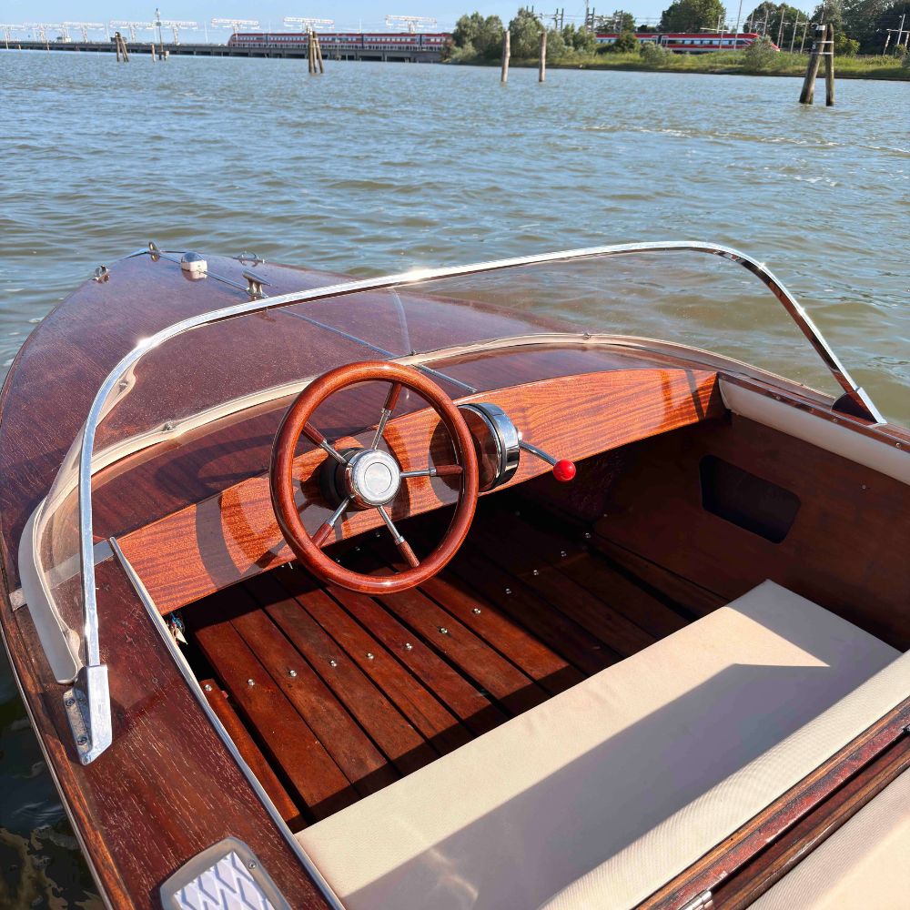 The mahogany hull of BELLA on the Venetian lagoon